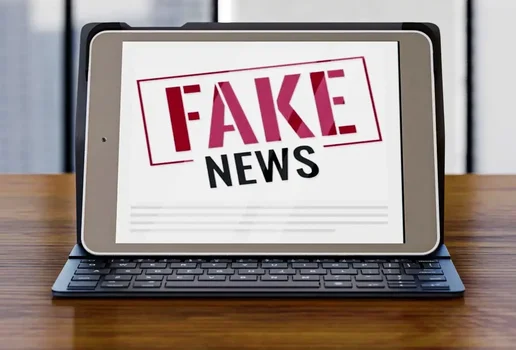 Front view laptop desk with fake news 0