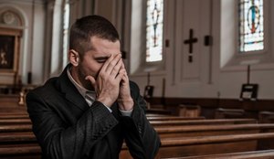 Man crying in church