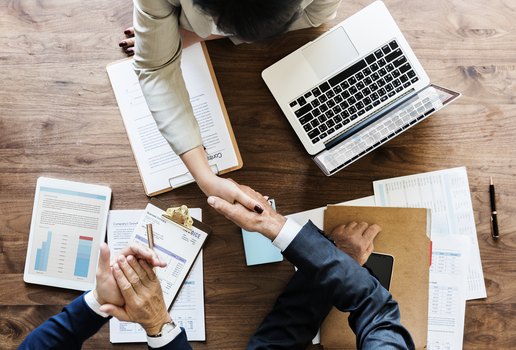 Business people shaking hands together